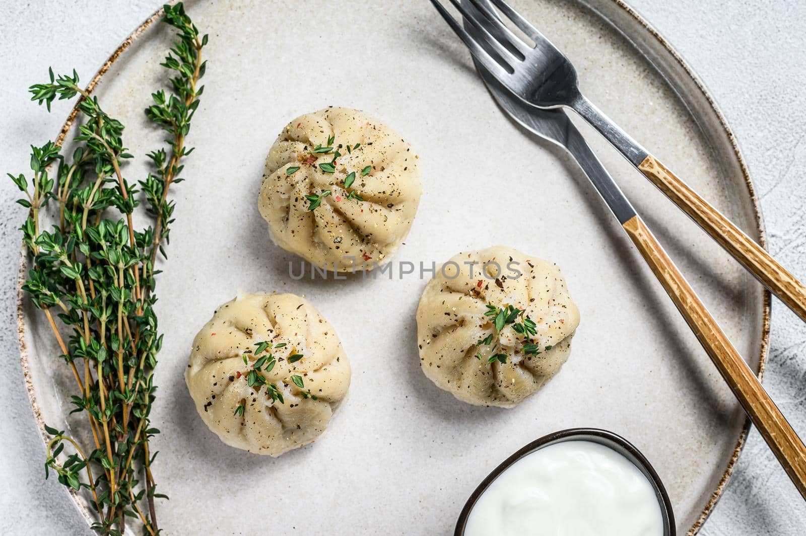 Asian Steamed Dumplings Manti with mince meat on a plate. White background. Top view by Composter