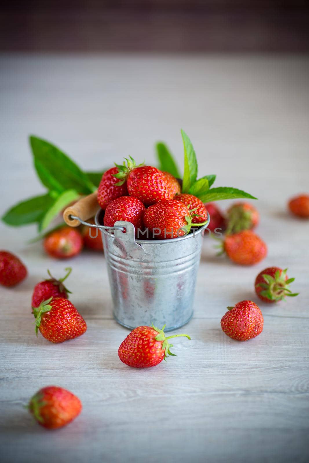 red ripe natural strawberries on a wooden table by Rawlik