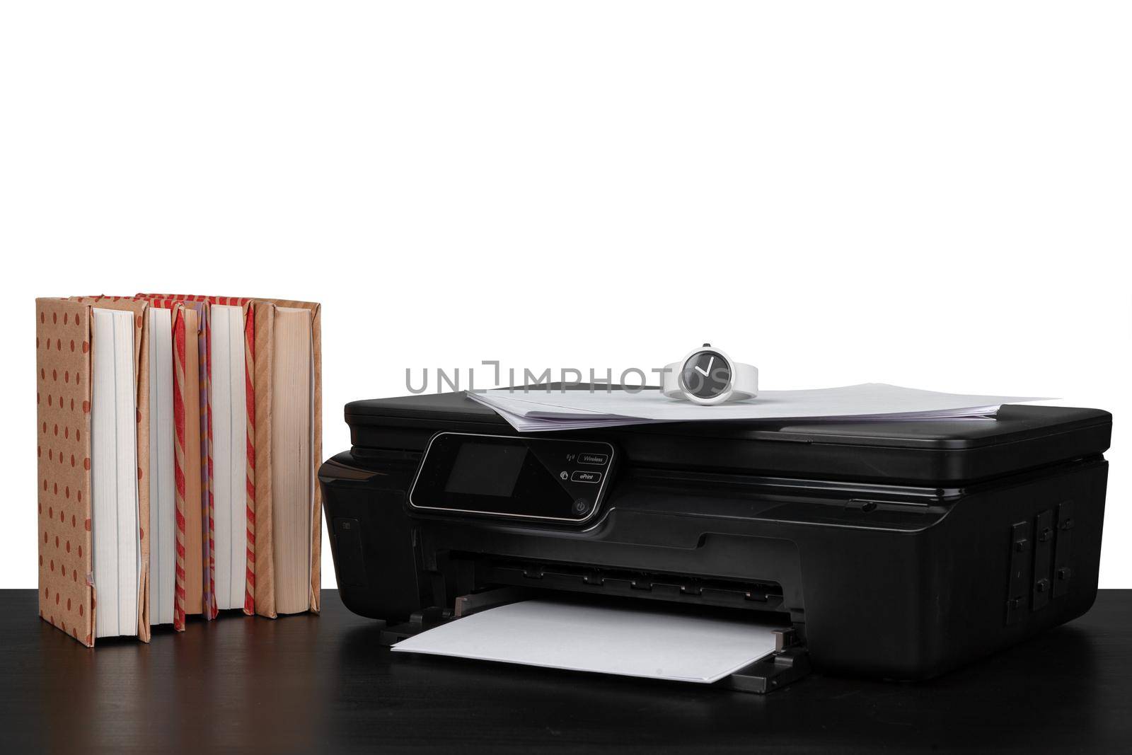 Working table with printer and stacked books on white abckground, close up
