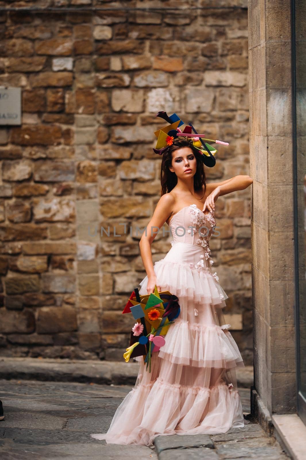 beautiful stylish girl model in a pink wedding dress photographed in Florence, holding an unusual bouquet, bride model with a bouquet in her hands, photo session of the bride in Florence