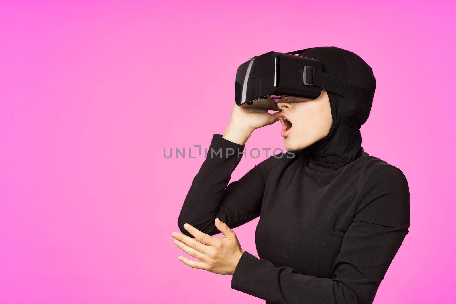 muslim woman wearing virtual reality glasses entertainment technology device by Vichizh