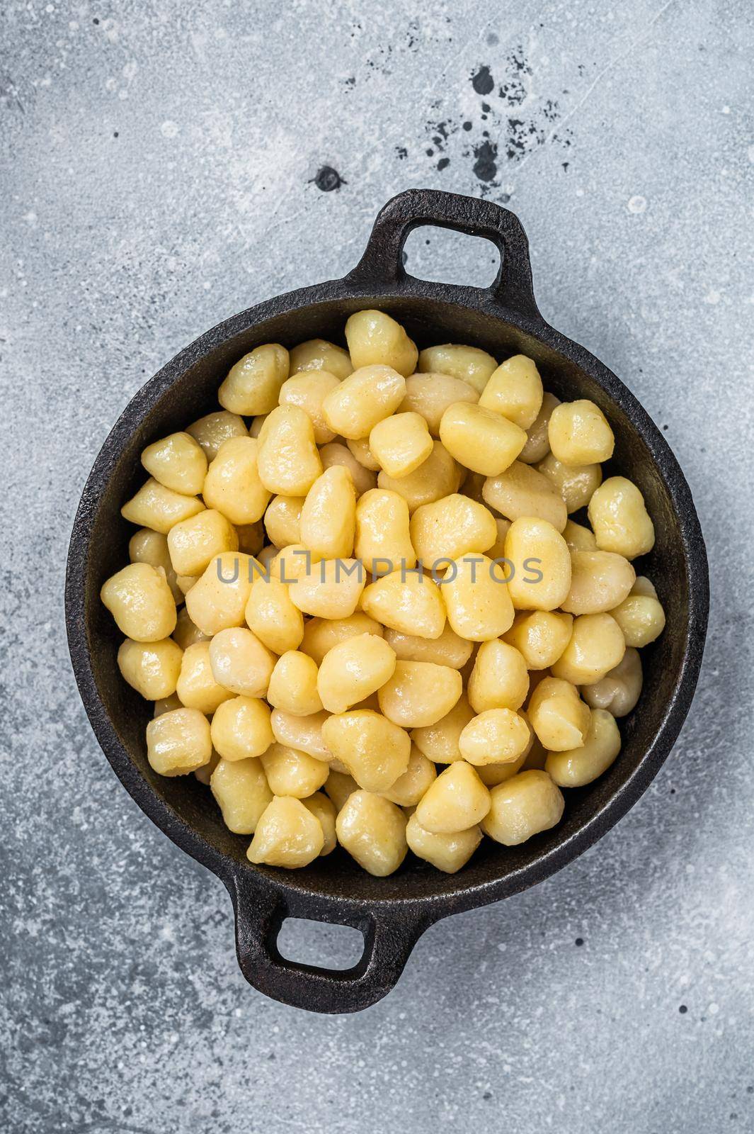 Cooked Gnocchi with Butter and Pepper. Gray background. Top view.