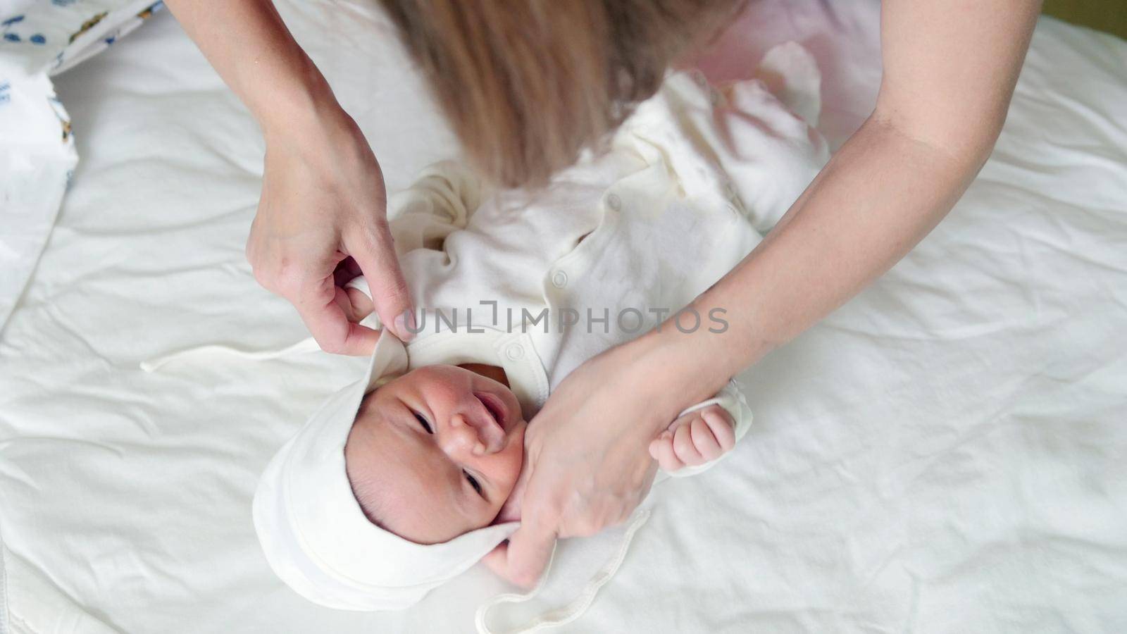 Mother is swaddling her child - newborn baby infant, close up