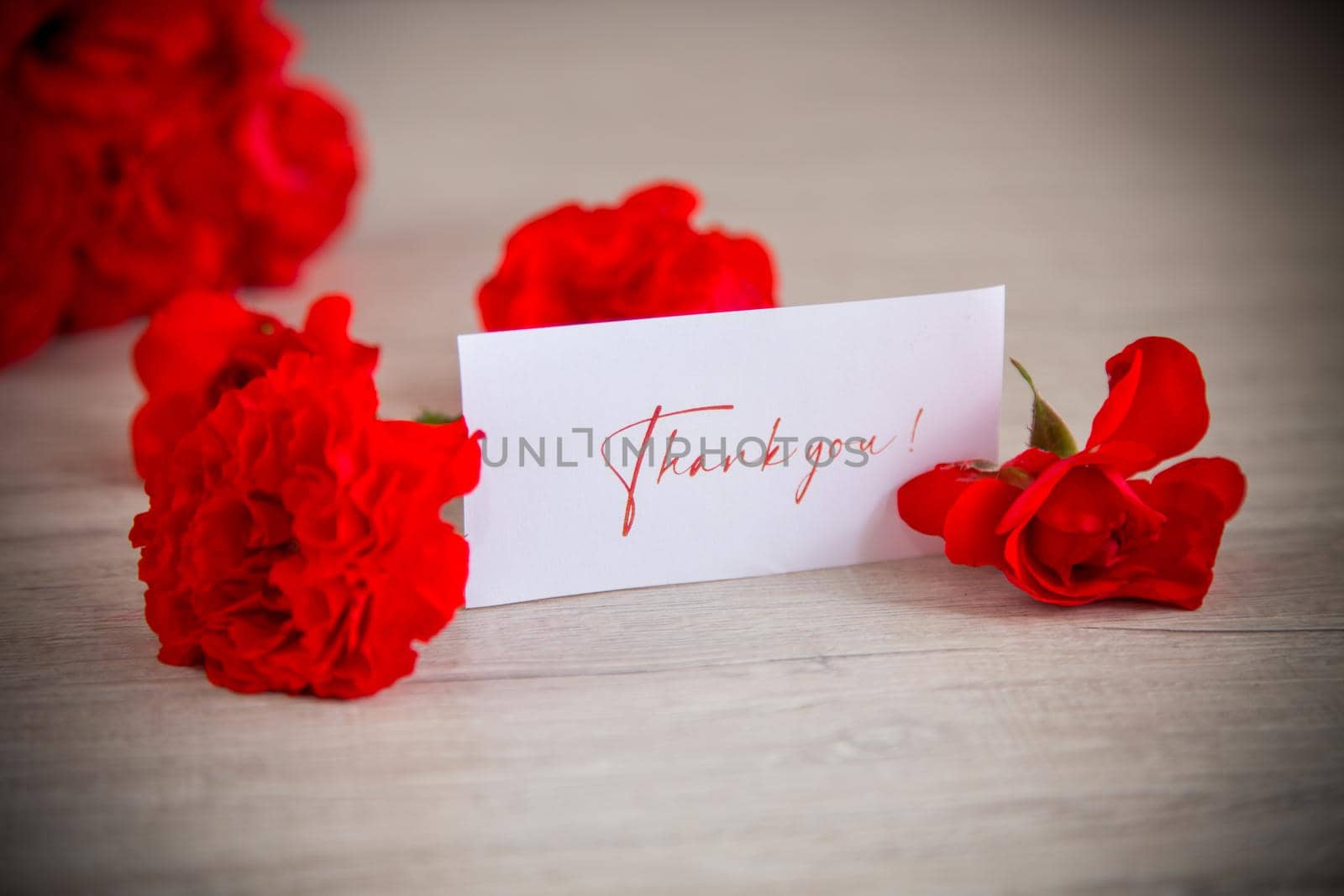 bouquet of beautiful red roses in a basket on a wooden table