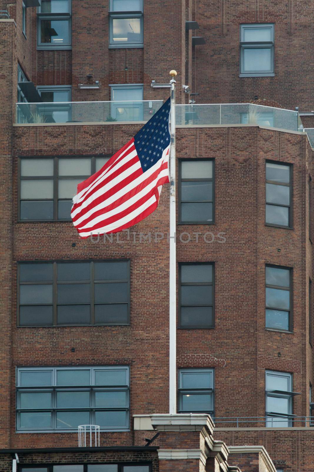 American flag on the brown brick building by Studia72