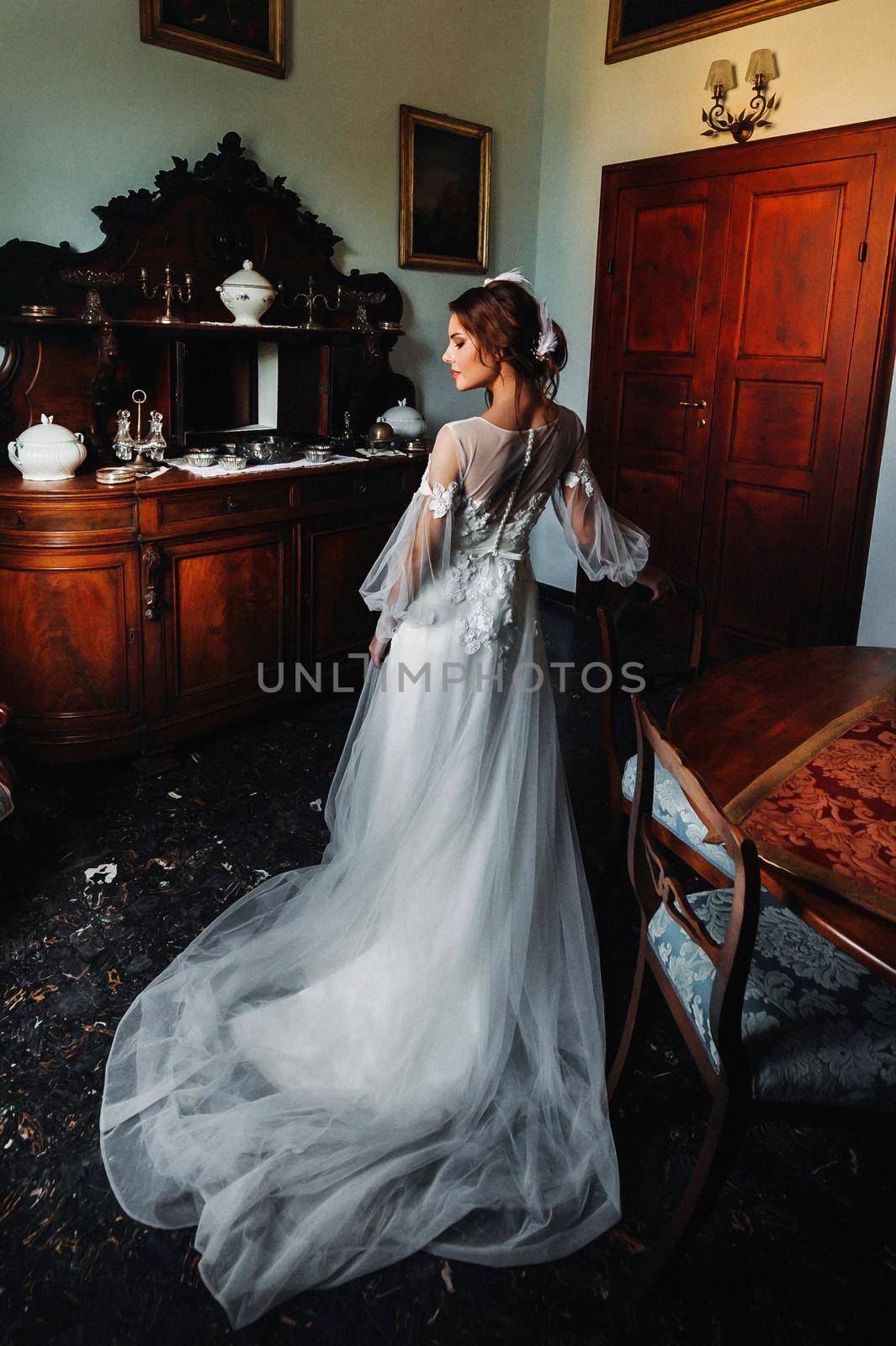 a bride in underwear and a white robe in the interior of a Villa in Italy at a wedding.morning of the bride in Tuscany.boudoir photo session at the Villa. by Lobachad