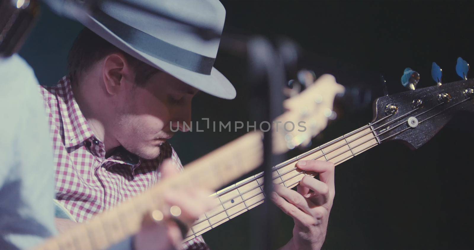 Blues in night club - guitarist plays guitar, close up, telephoto
