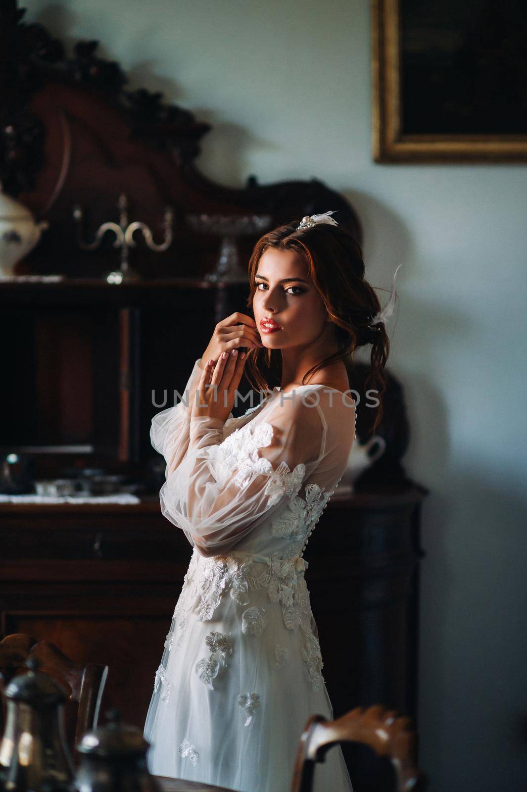 a bride in underwear and a white robe in the interior of a Villa in Italy at a wedding.morning of the bride in Tuscany.boudoir photo session at the Villa