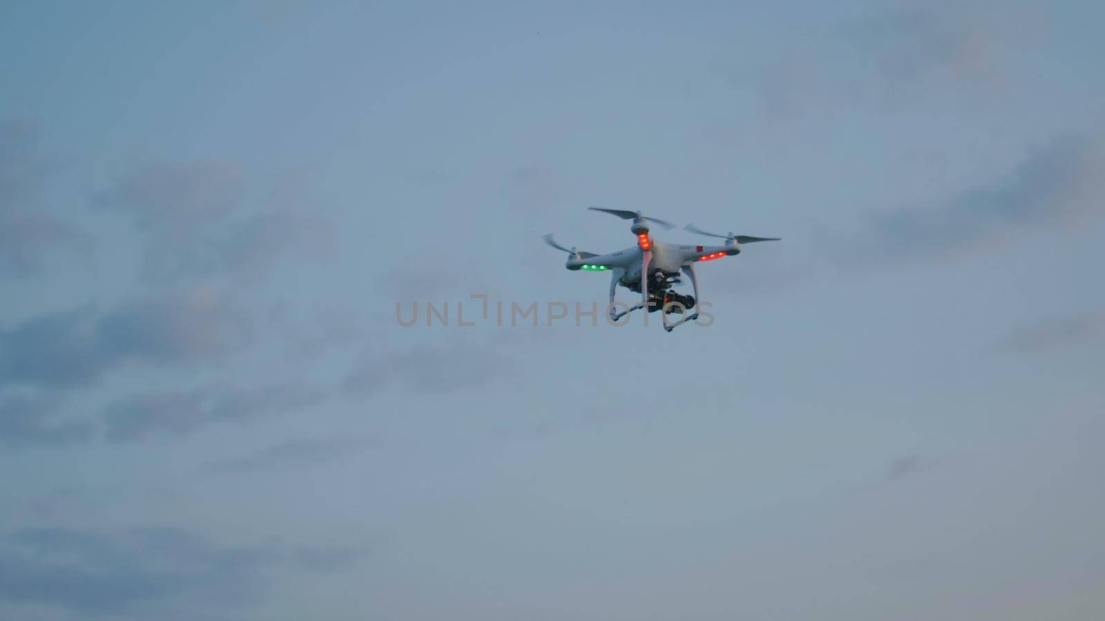 Video Drone flying in the evening summer sky with clouds, telephoto