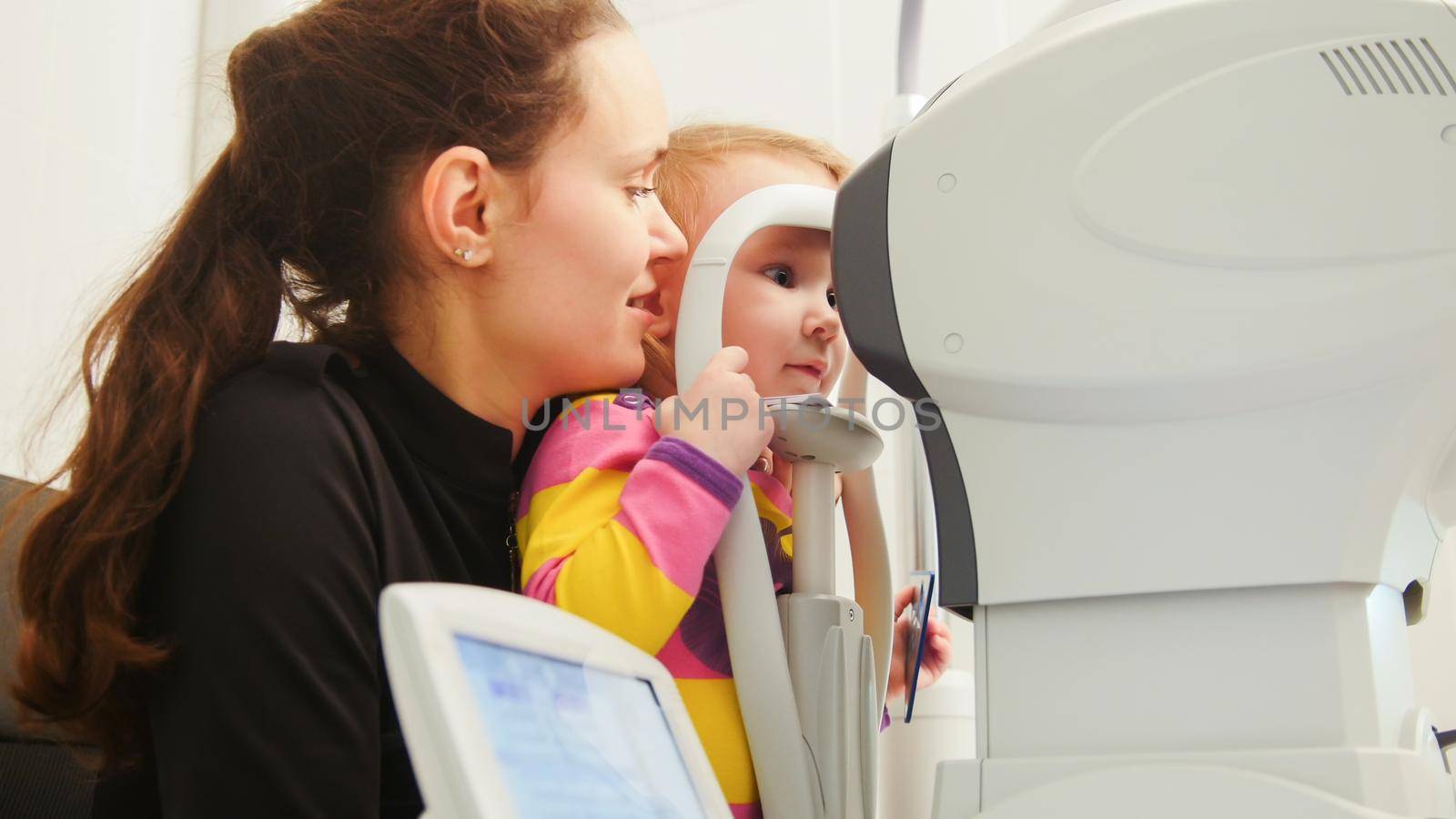 Children ophthalmology - optometrist Checks Child's Eye, horizontal