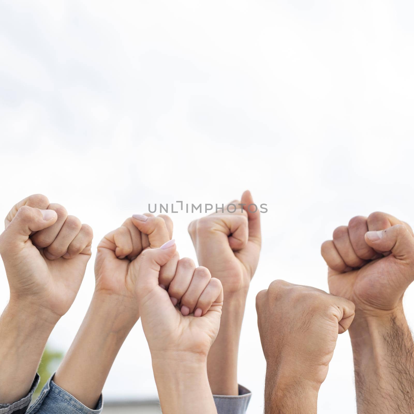 group activists holding fists up by Zahard