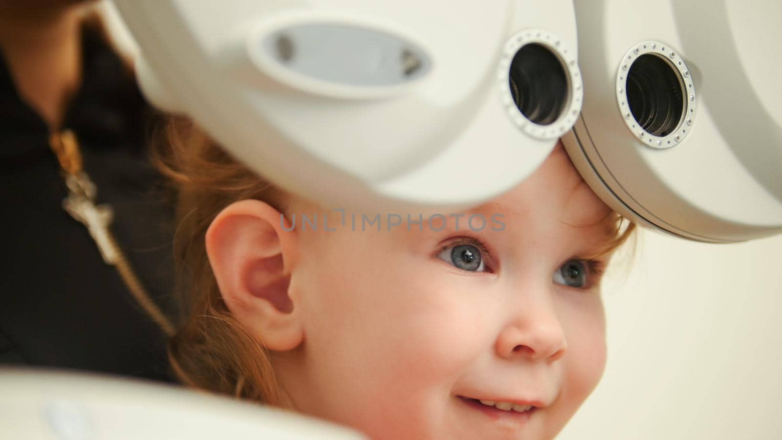 Healthcare - little cute girl in ophthalmologist room, close up
