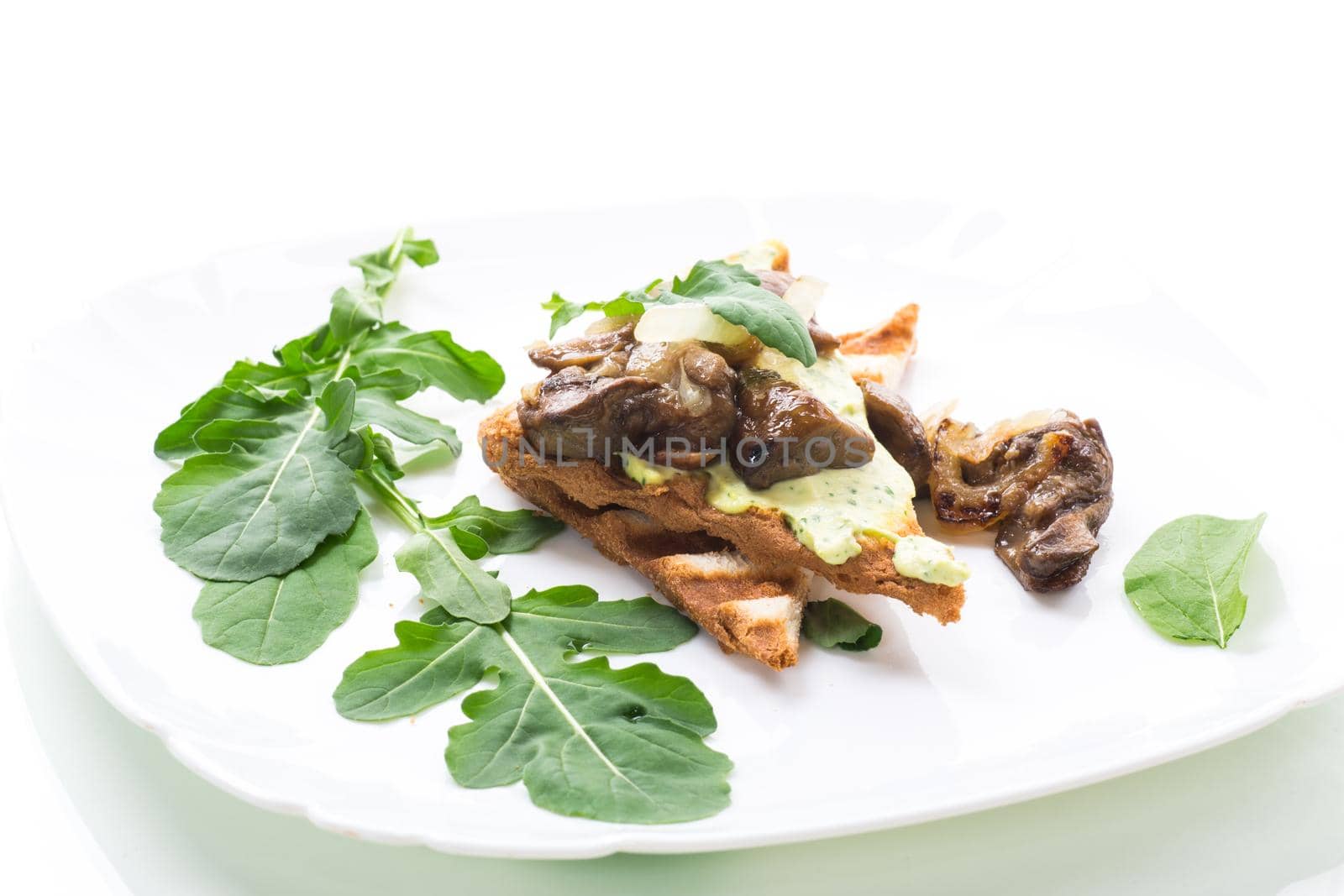 fried toast with cheese spread, arugula and fried mushrooms isolated on white background