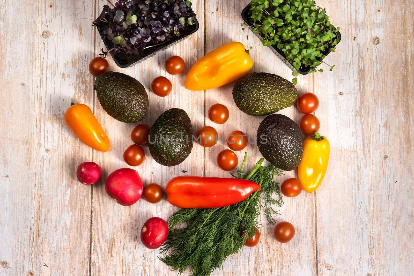 Assorted vegetables lying on a wooden table.