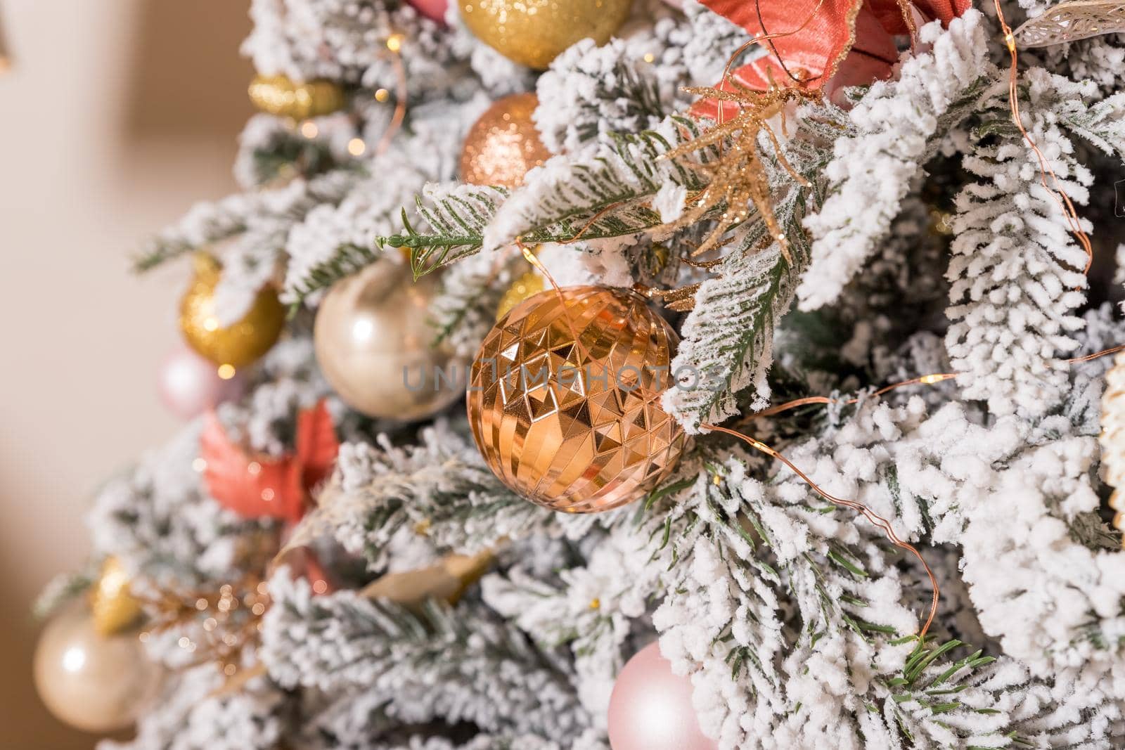 Christmas toys on a fir-tree close up with interior background