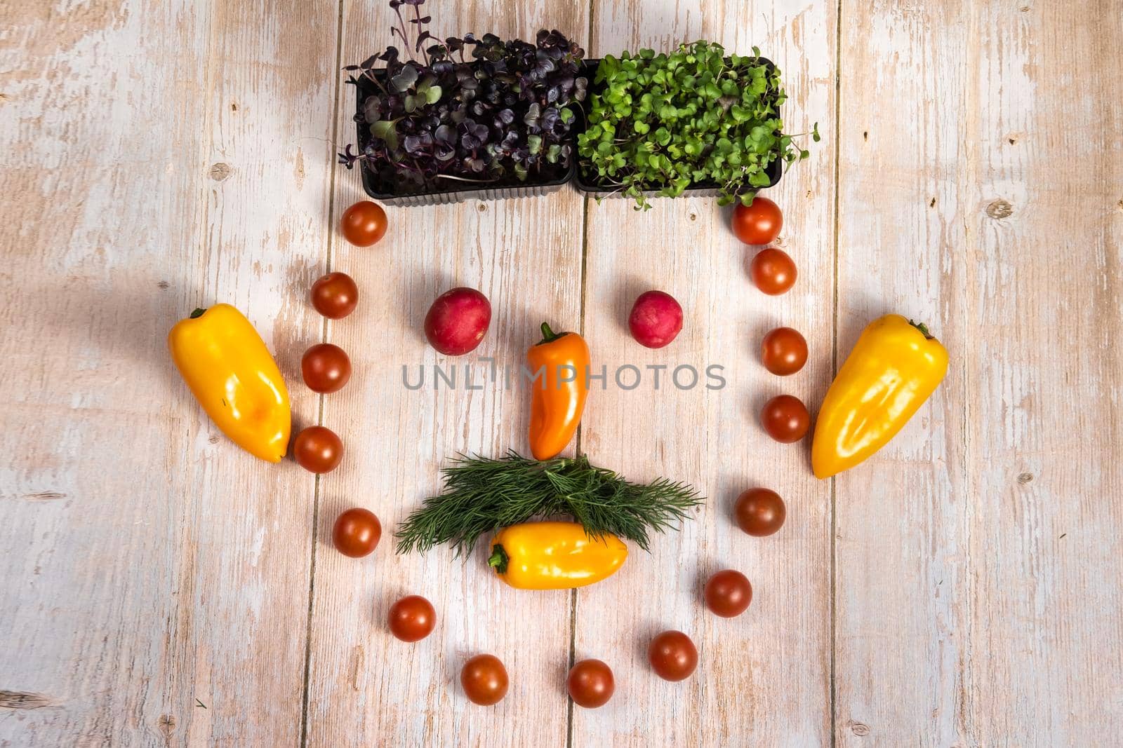 The face of a man made of sliced vegetables on a wooden background.