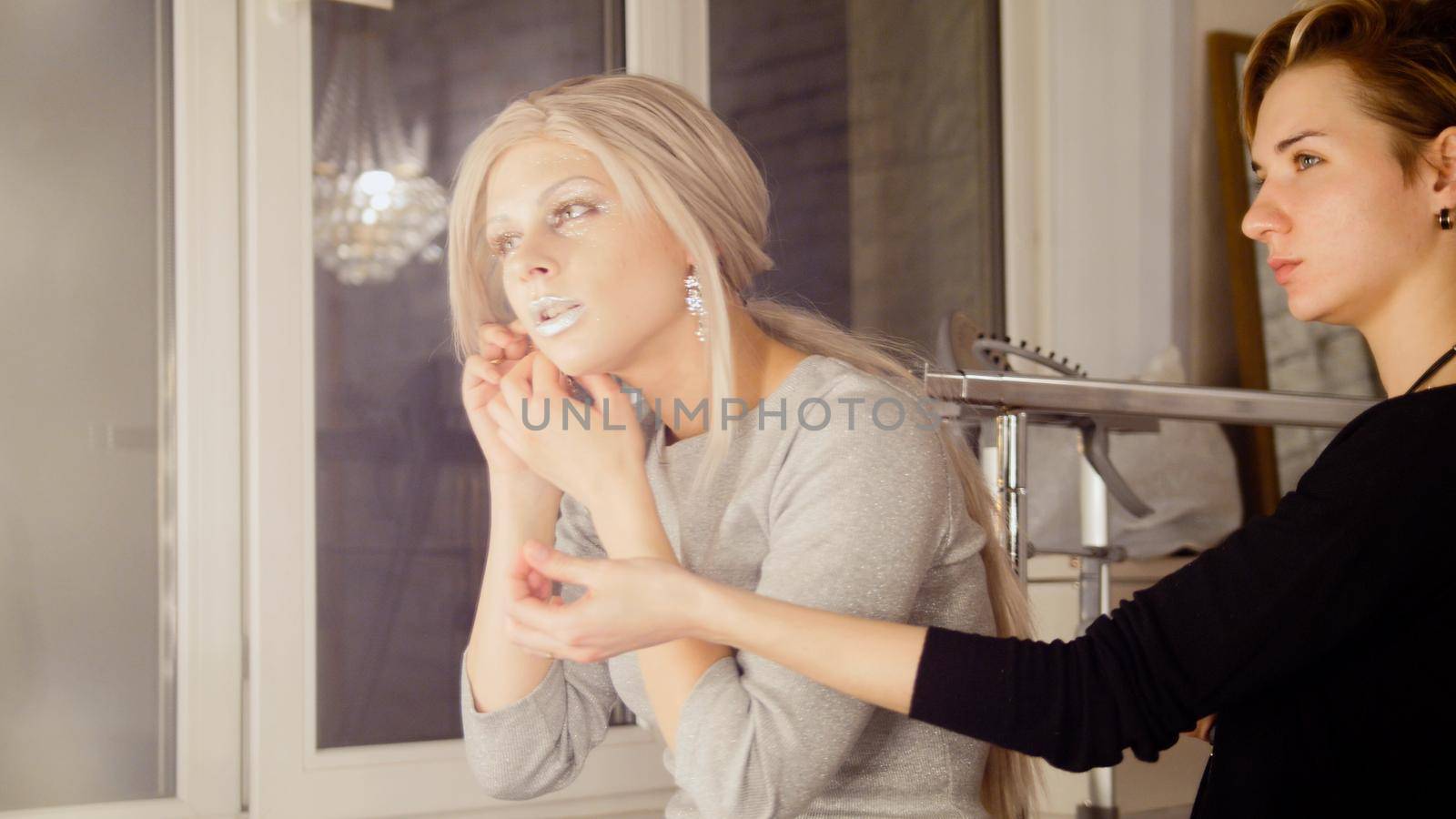 Beauty shop: attractive young woman model wear earrings, close up