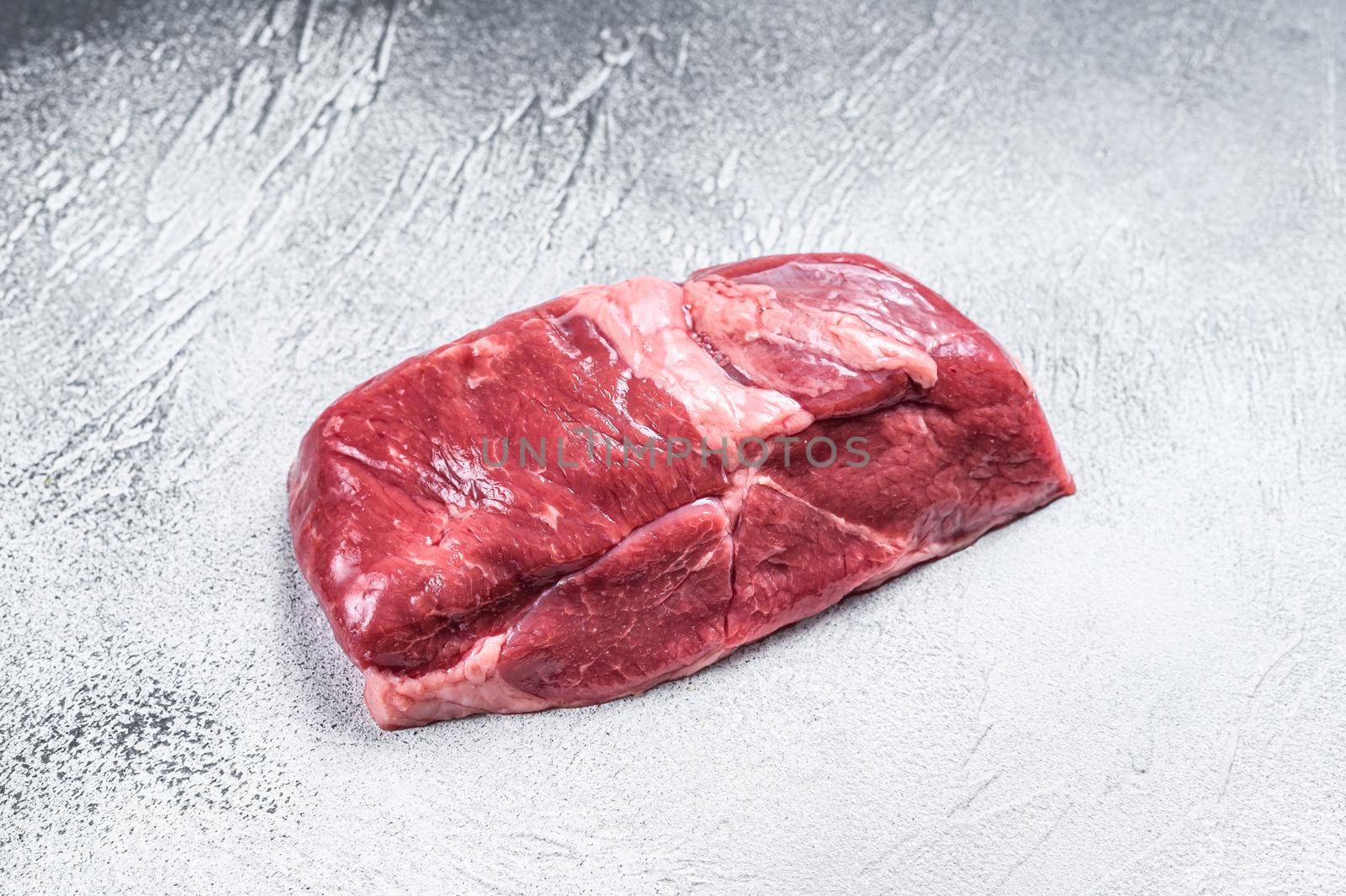 Raw lamb meat leg steak. White background. Top view. Copy space.