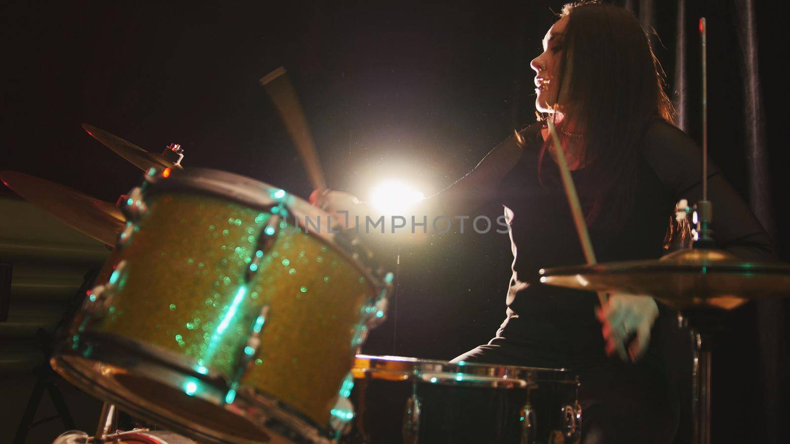 Gothic black hair girl percussion drummer perform music break down - teen rock music, telephoto