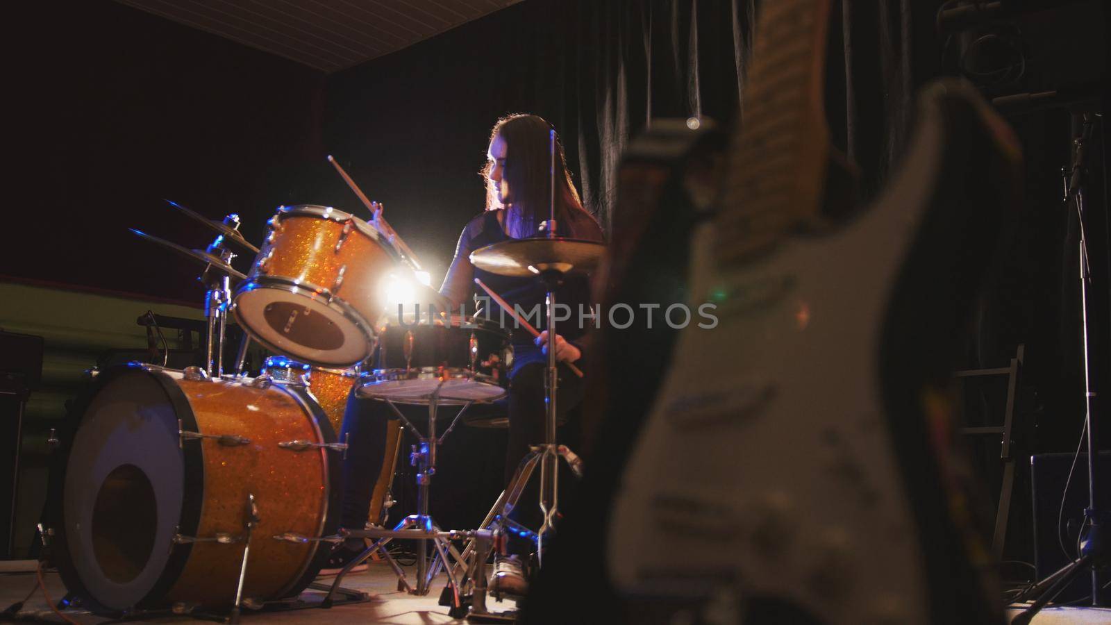 Girl drummer, attractive young woman plays the drums, horizontal