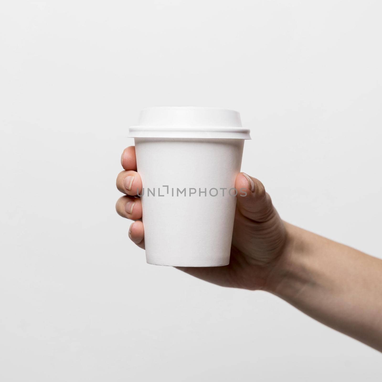 hand holding white coffee cup close up by Zahard