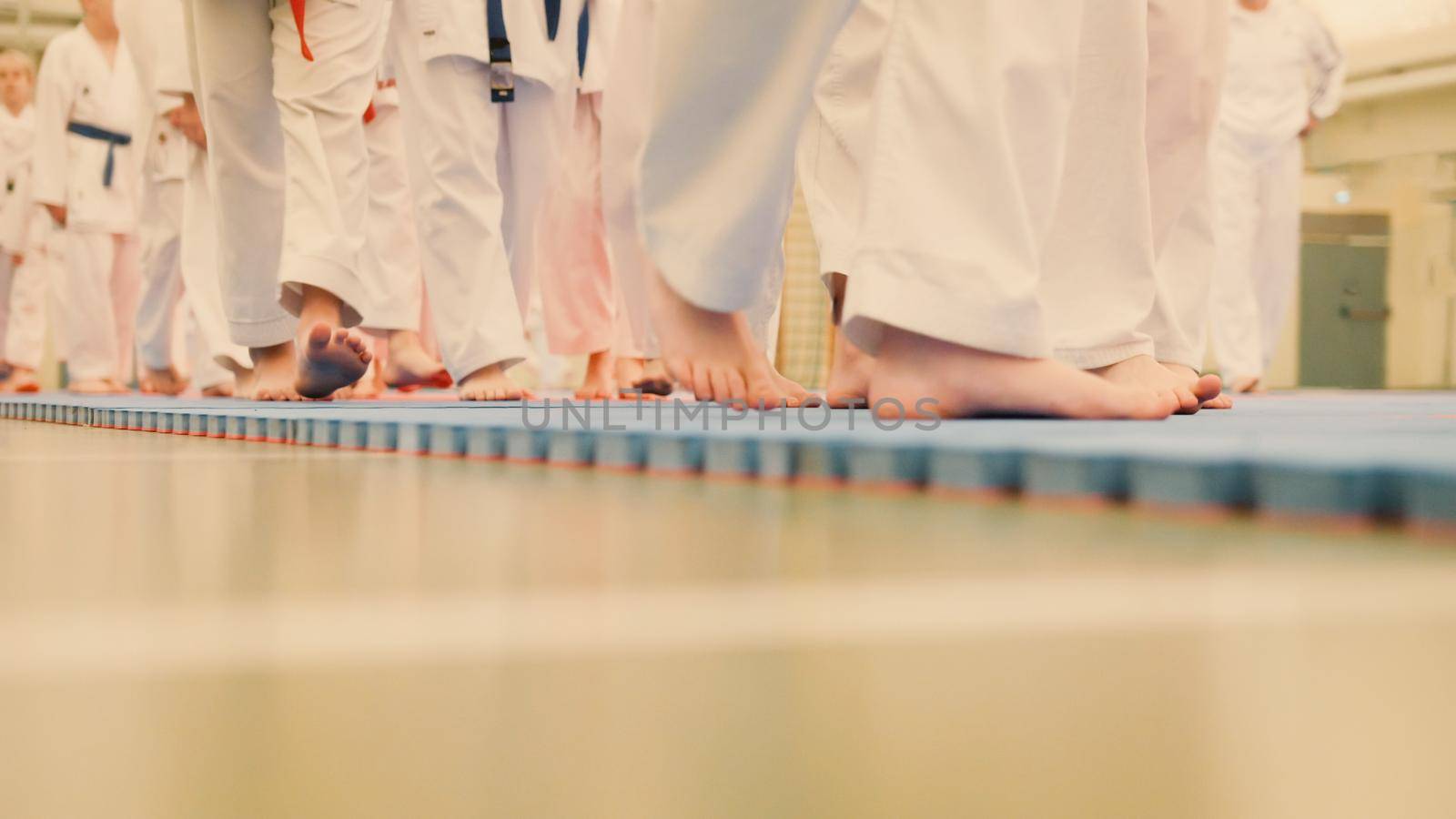 Karate training - group of karateka teenagers in kimono, close up