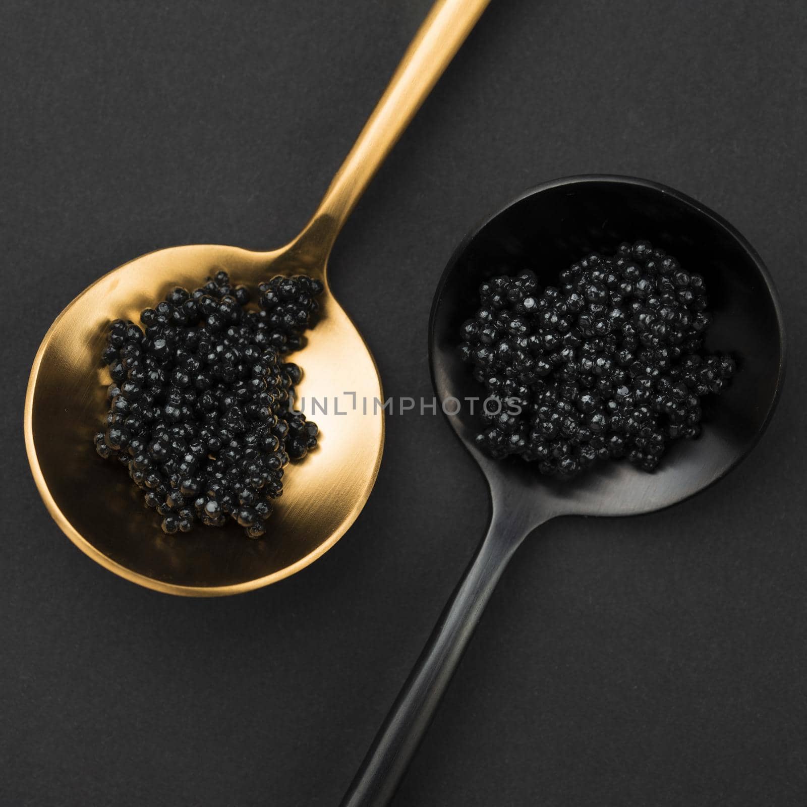 golden and black spoon with caviar by Zahard