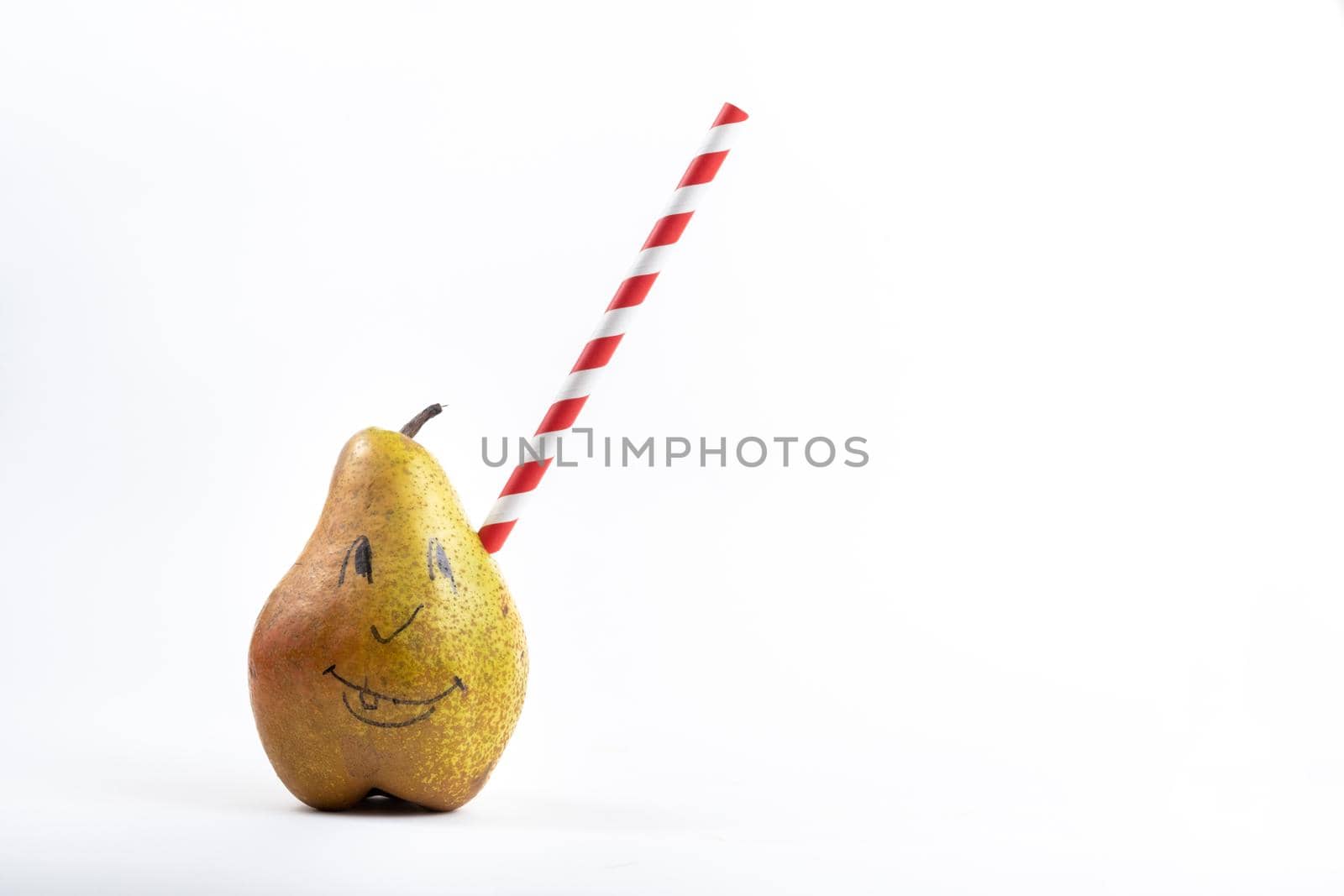 A large pear with a drinking tube sticking out of it on a white background.