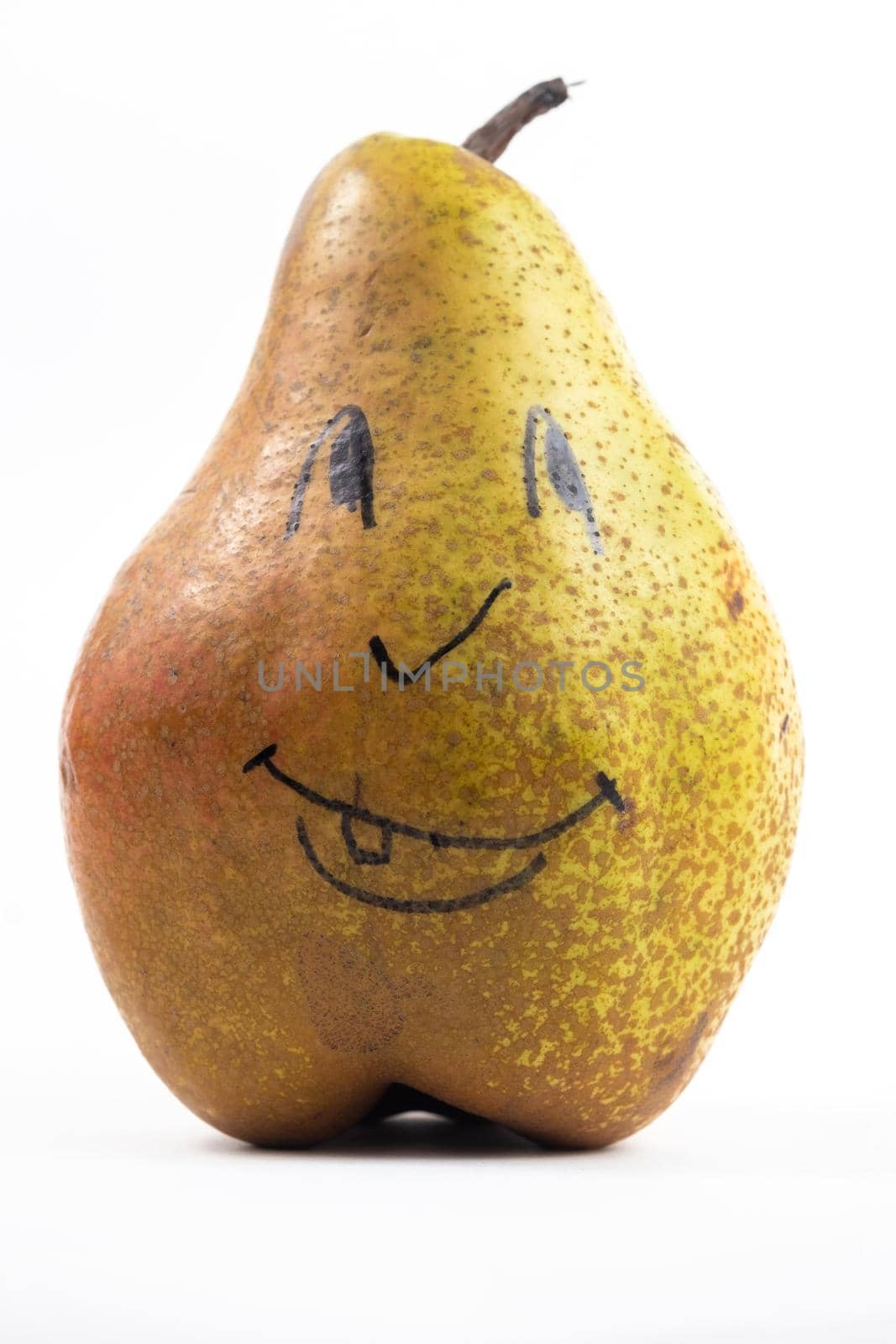 A large pear with a painted smiley face on a white isolated background.