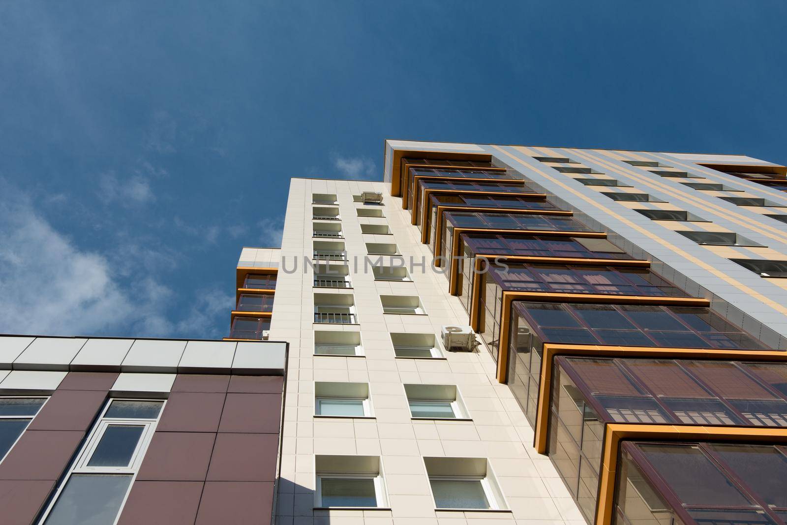 Multi-storey residential apartment buildings over blue sky, horizontal