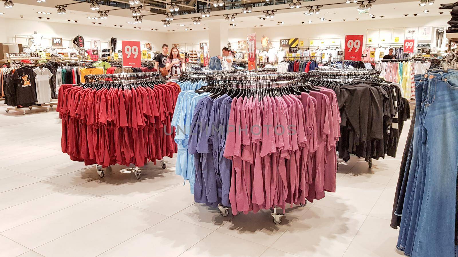 Ukraine, Kiev - September 04, 2019: A large clothing store, mannequins and many rows with hangers, a variety of sizes and colors. Black Friday, a day of shopping and sales at boutiques and malls.
