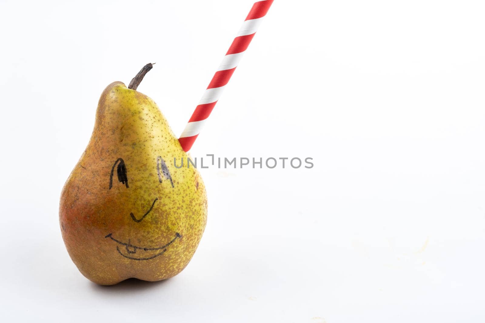 A large pear with a drinking tube sticking out of it on a white background.