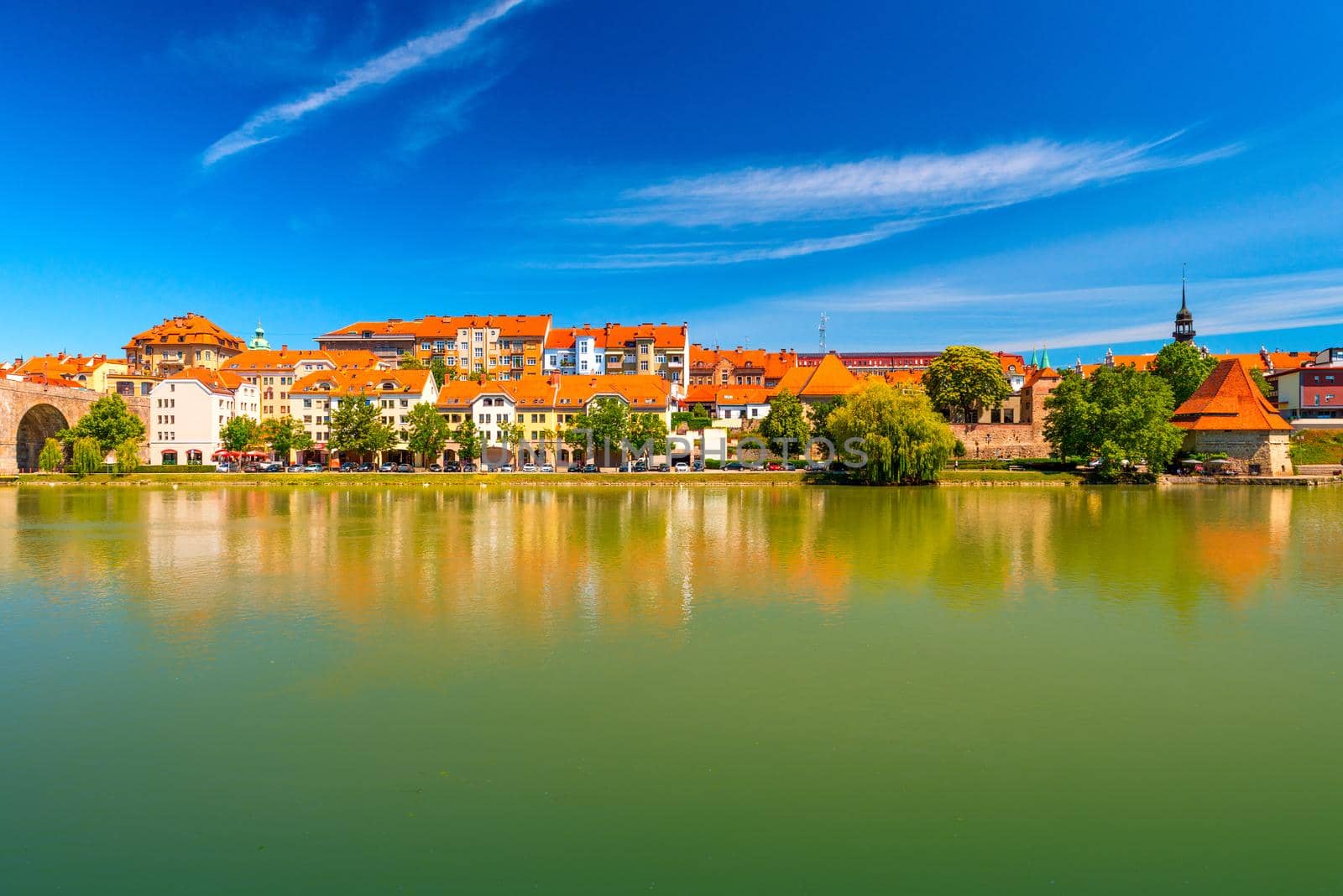 Cityscape of Maribor reflected in the water, Slovenia
