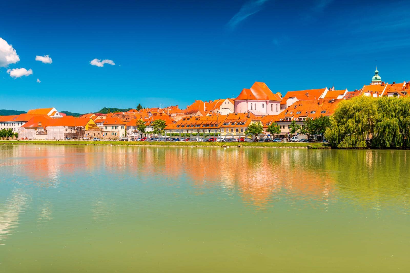 Historic buildings of Maribor reflected in the water of the river Drava, Slovenia