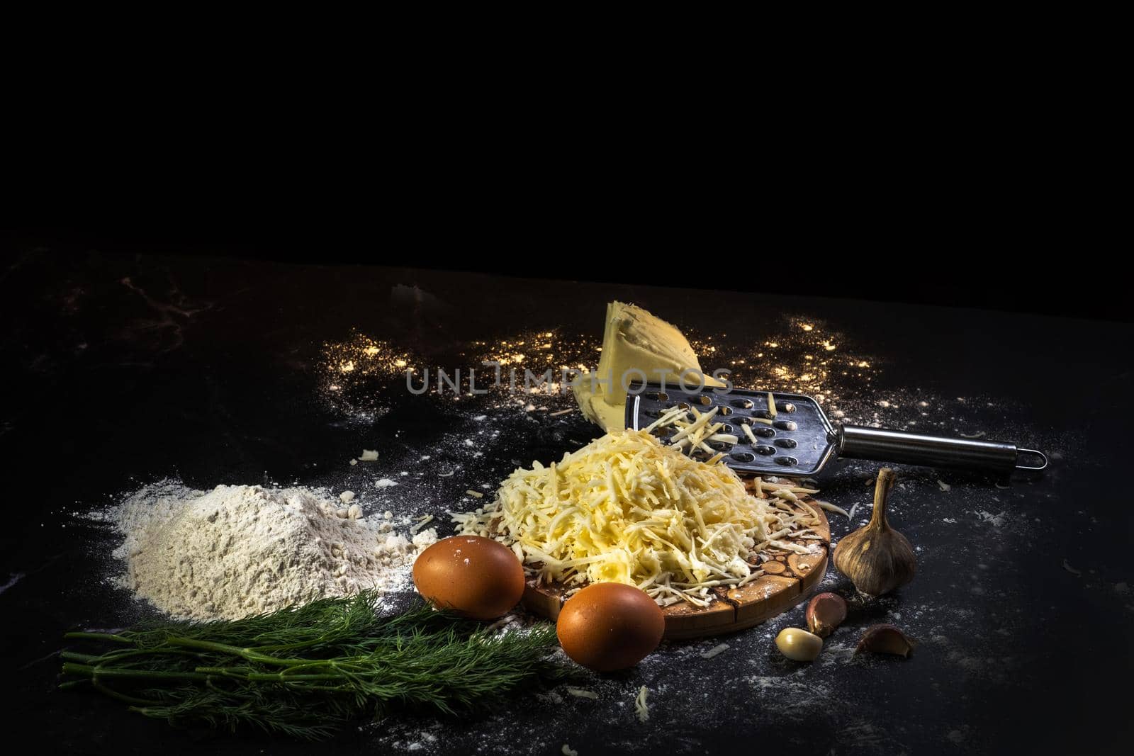 preparation of the process of cooking cheese balls with garlic and dill on a black background by Lobachad
