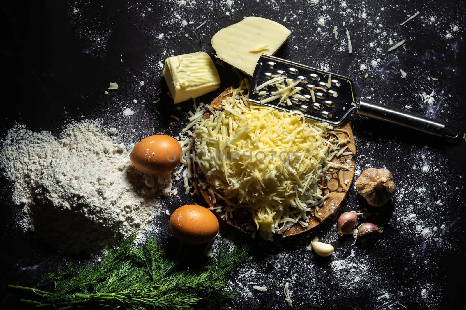 still life of the process of making cheese balls with garlic and dill on a black background by Lobachad