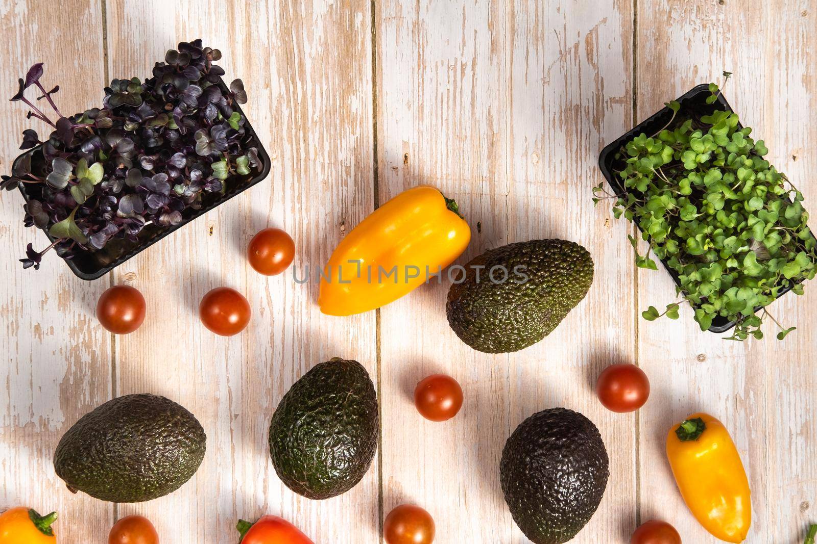 Assorted vegetables lying on a wooden table.