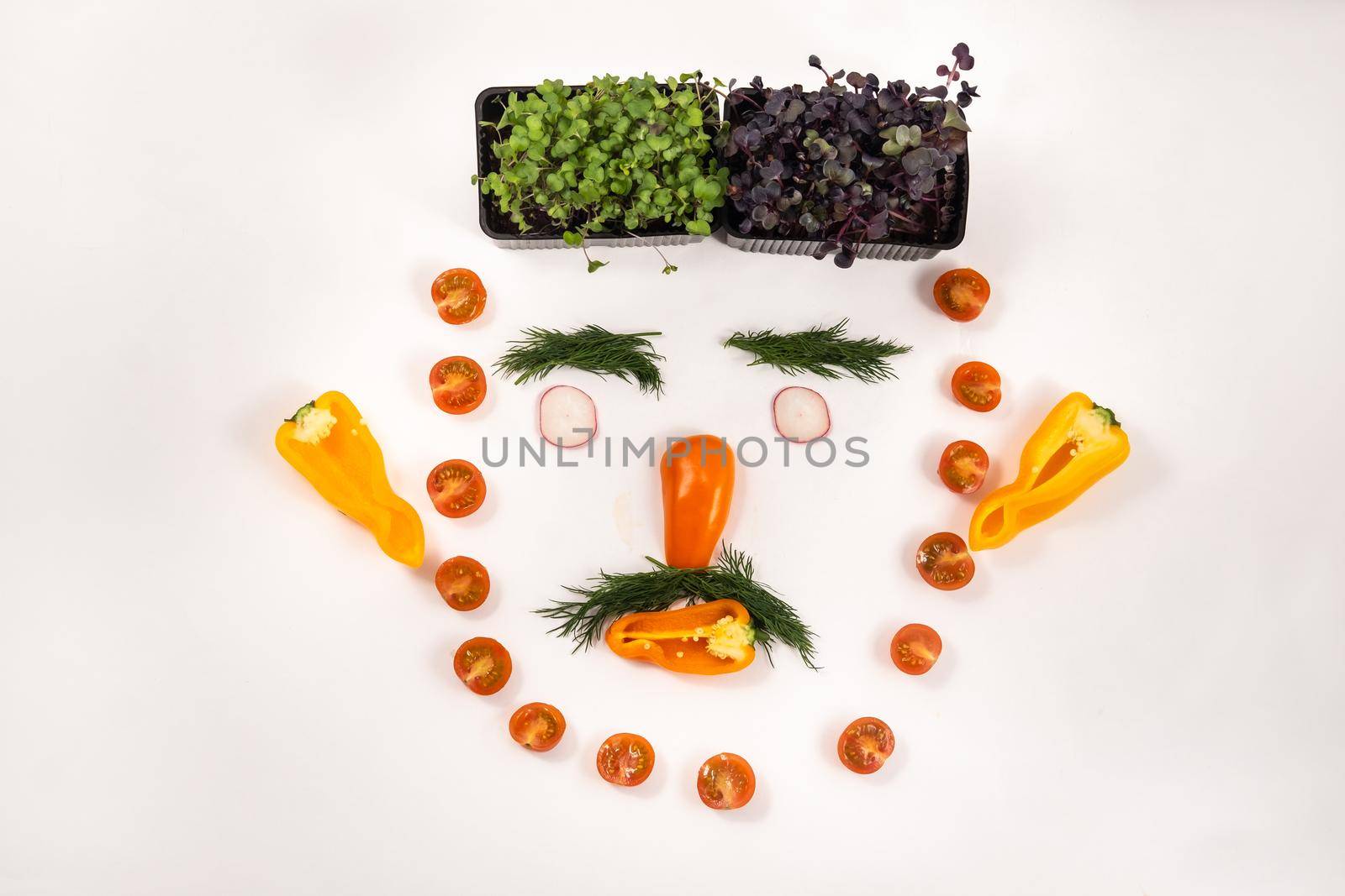 A person's face made of vegetables on a white background.