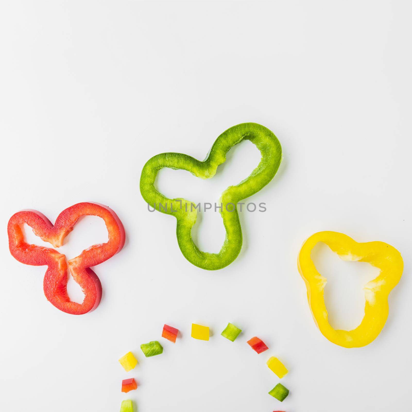 high angle view multi colored fresh bell peppers white backdrop by Zahard