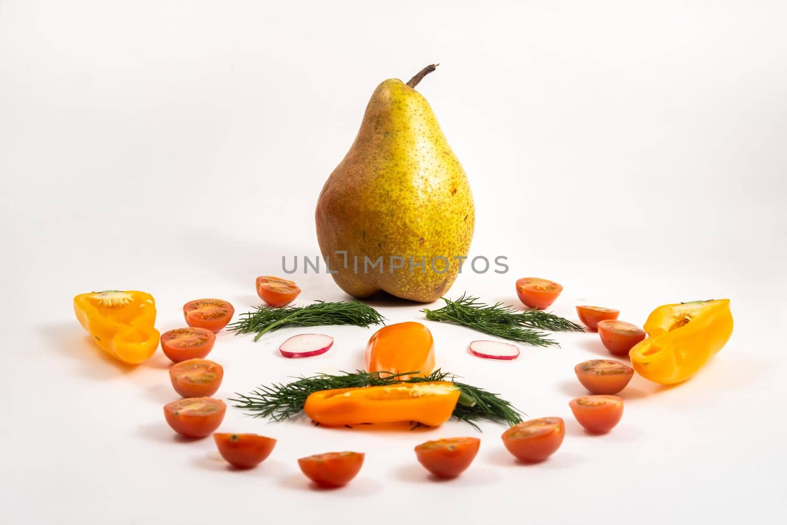 The face of a man made of sliced vegetables and a pear on his head on a white background.