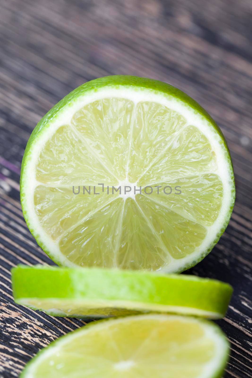 green lime chopped into slices for use in a dish, closeup