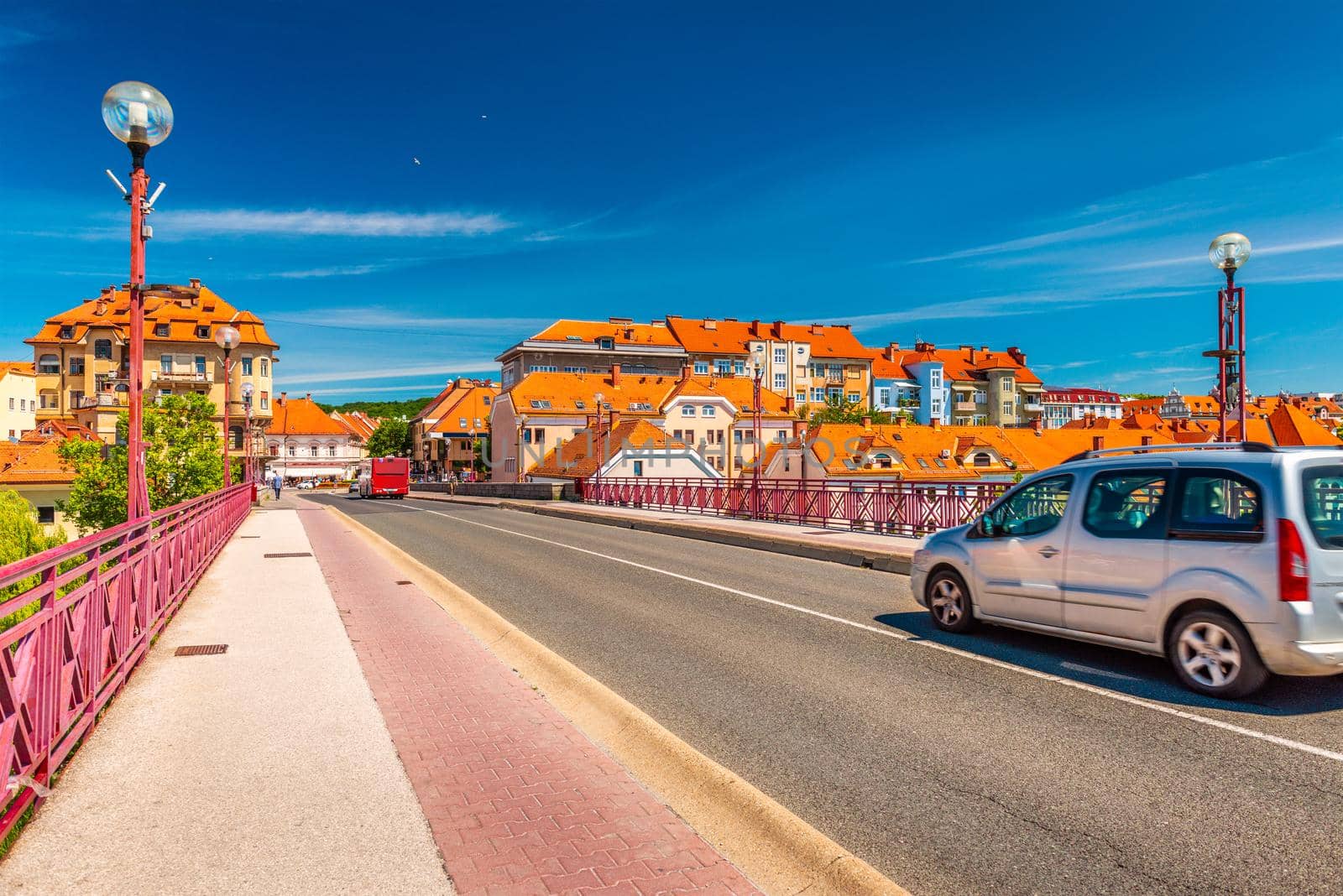 A car is driving across the Old Bridge (Glavni Most) of Maribor towards the city center, Slovenia