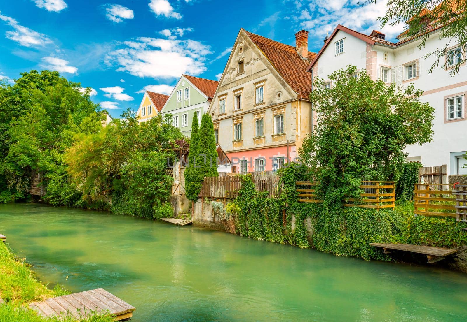 Steyr - July 2020, Austria: A row of residential buildings and a canal with water in the medieval Austrian city of Steyr