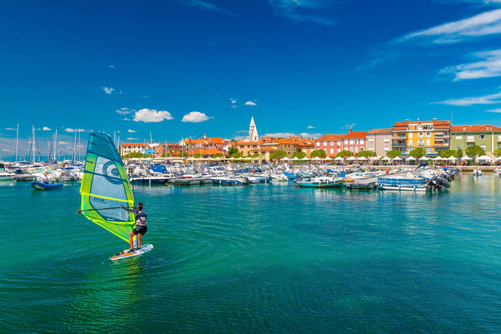 Izola - June 2020, Slovenia: A woman windsurfing in the harbor of Izola