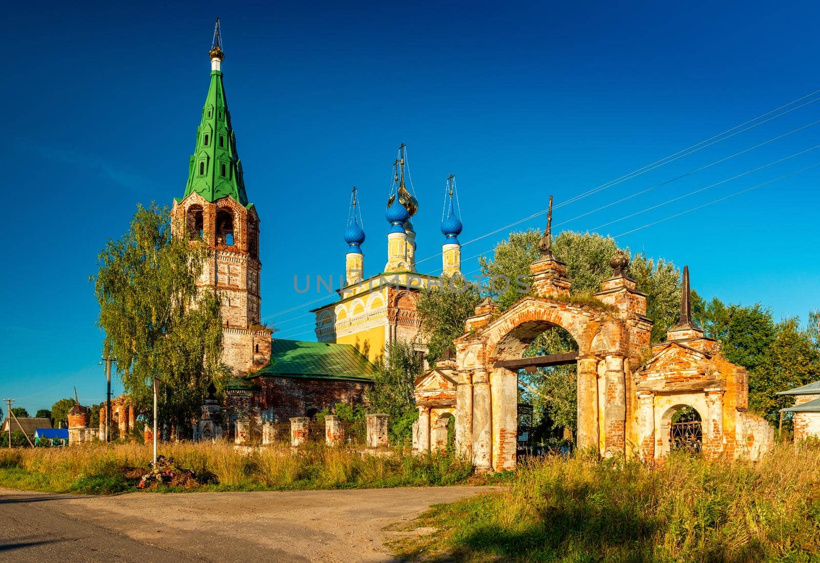 Dunilovo - September 2020, Russia: Church of the Nativity of the Virgin and the entrance gate to Voznesenskaya Church (Church of the Ascension