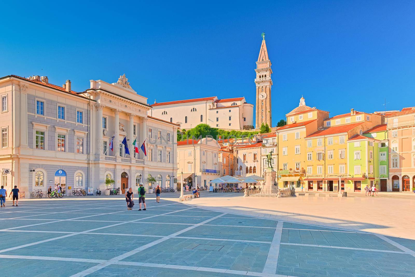 Piran - July 2020, Slovenia: View of the main square of Piran (Tartini Square) with colorful architecture and walking people