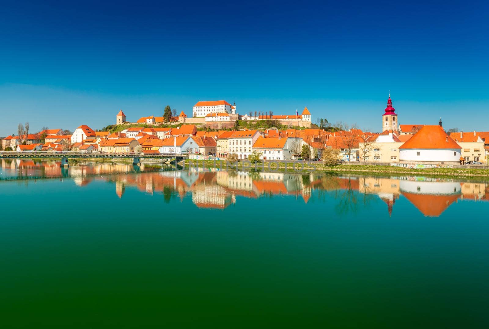 Ptuj - March 2021, Slovenia: Panoramic view of the ancient Slovenian town of Ptuj reflected in the water