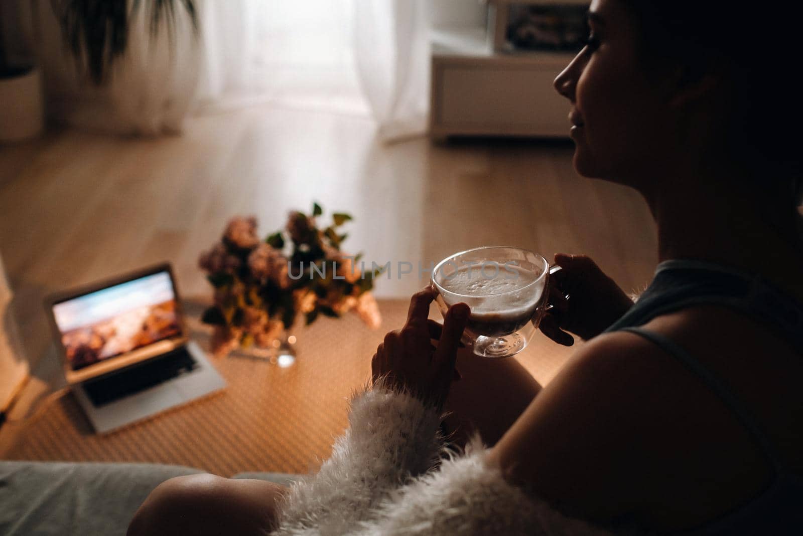 relaxed girl at home drinking coffee.Inner peace.The girl is sitting comfortably on the sofa and drinking coffee.