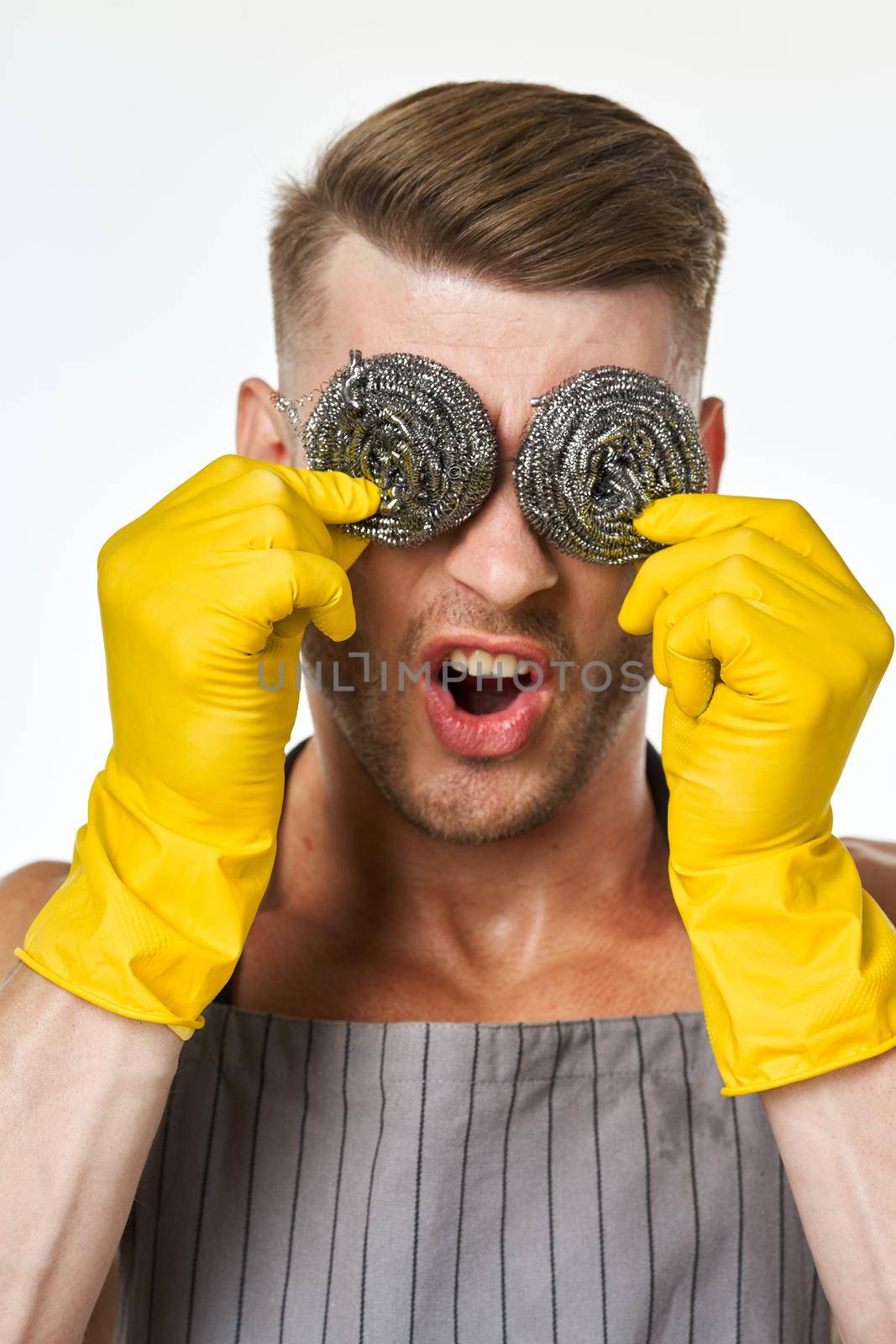 pumped up man in rubber gloves metal sponges close-up by Vichizh