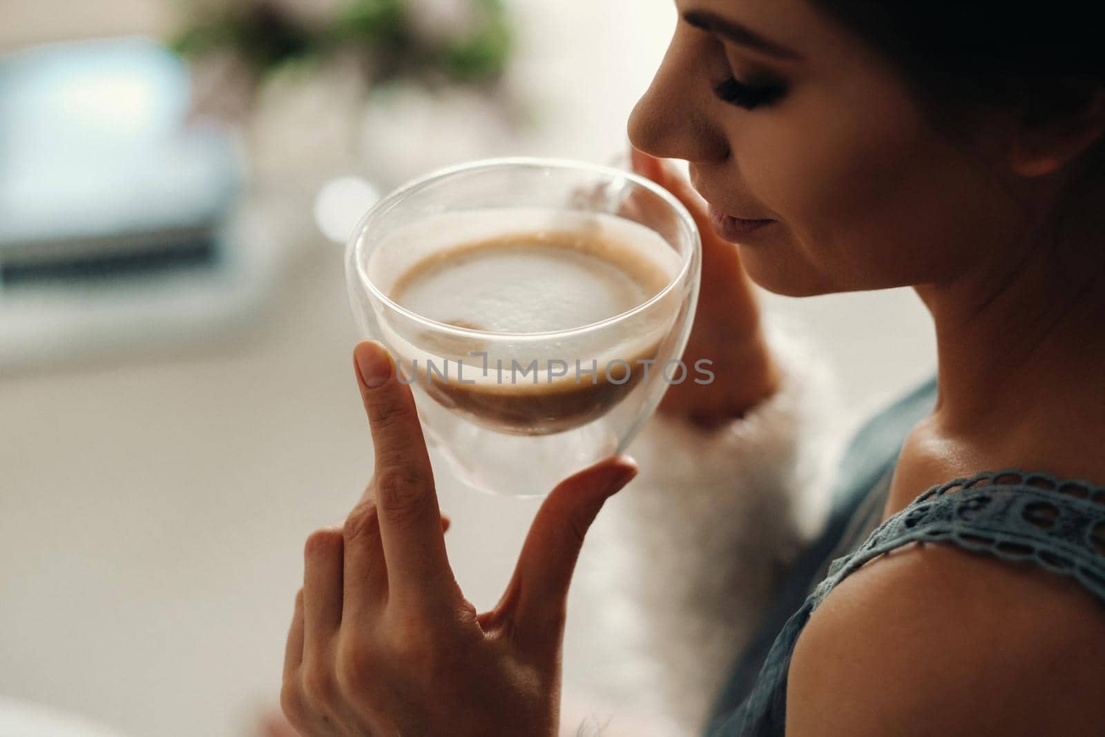 relaxed girl at home drinking coffee.Inner peace.The girl is sitting comfortably on the sofa and drinking coffee.